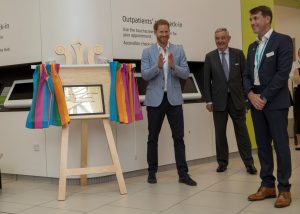 Prince Harry unveils a special plaque to officially open the new hospital wing