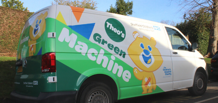 Photograph of green electric van with Theo bear on