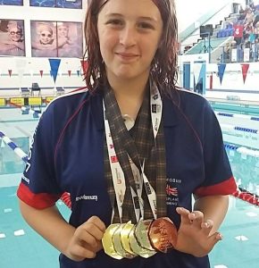 smiling patient Ellie with her medals 