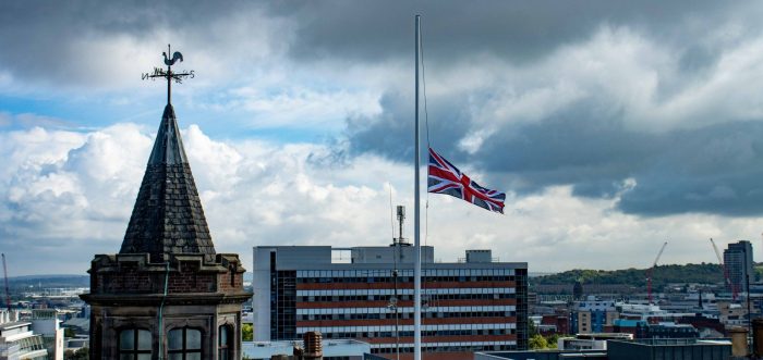 stormy sky above sheffield with flag at half mast