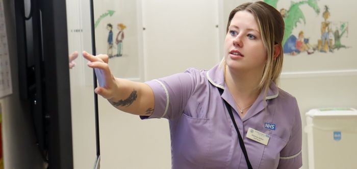 A nurse uses the new whiteboards