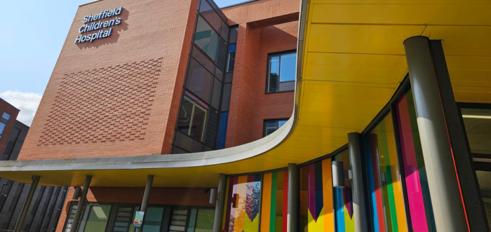 yellow ceiling with rainbow coloured glass with blue sky above sheffield children's hospital building